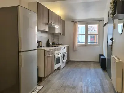 a kitchen with a refrigerator and a washer and dryer at Renovated 2-room apartment in historic center in Aix-en-Provence