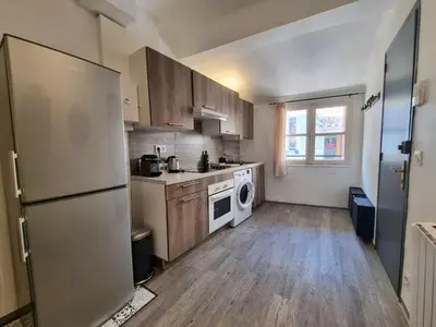 a kitchen with a refrigerator and a dishwasher at Renovated 2-room apartment in historic center in Aix-en-Provence