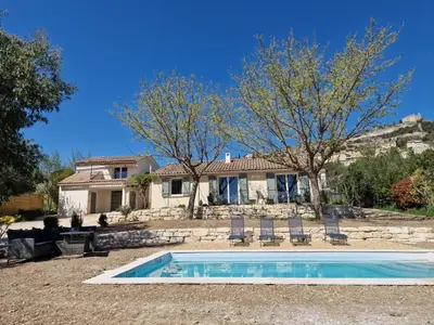 a house with a swimming pool in front of a house at L'Oustalet des Vignes in Saint-Saturnin-les-Apt