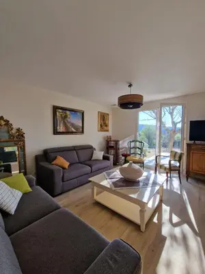 a living room with two couches and a coffee table at L'Oustalet des Vignes in Saint-Saturnin-les-Apt