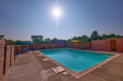 a large swimming pool with chairs around it at Maison provençale avec jardin in Velleron