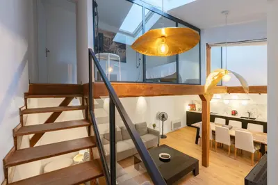 a staircase leading to a living room and a dining room at Appartement T4 plein centre ville escalier étroit in Aix-en-Provence