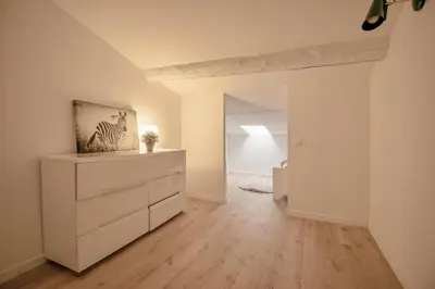 an empty living room with a dresser and a bedroom at Appartement T4 plein centre ville escalier étroit in Aix-en-Provence