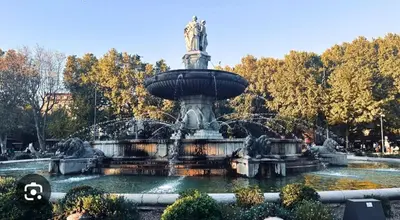 a fountain in a park with a statue at Appartement T4 plein centre ville escalier étroit in Aix-en-Provence