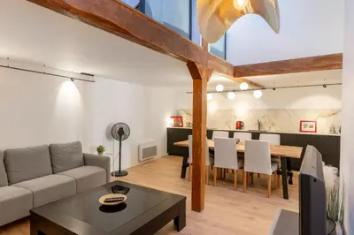 a living room with a couch and a table at Appartement T4 plein centre ville escalier étroit in Aix-en-Provence