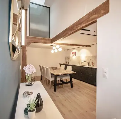 a dining room and kitchen with a table and chairs at Appartement T4 plein centre ville escalier étroit in Aix-en-Provence