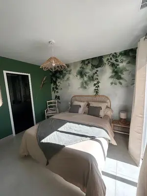 a bedroom with a large bed with green walls at Le Bonheur à Ventoux in Saint-Pierre-de-Vassols