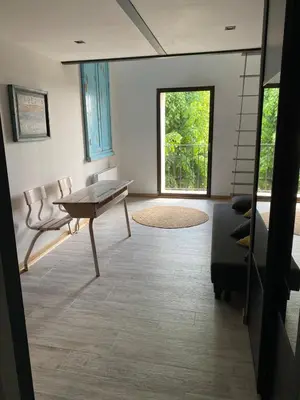 a living room with a table and a couch at Coudignac 1891 in Lagnes