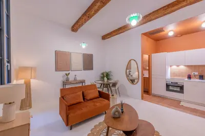 a living room with a couch and a table at Appartement Belle Lettre 5 in Aix-en-Provence