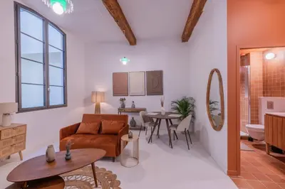 a living room with a couch and a table at Appartement Belle Lettre 5 in Aix-en-Provence