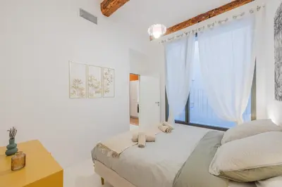 a bedroom with a bed and a large window at Appartement Belle Lettre 5 in Aix-en-Provence
