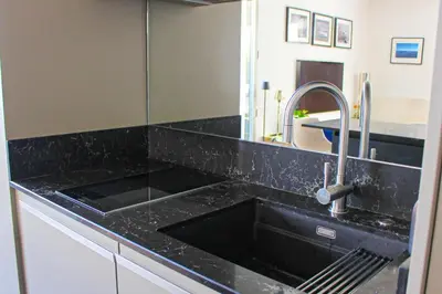 a kitchen with a black counter top with a sink at Spacious Duplex with Terrace City Center in Aix-en-Provence