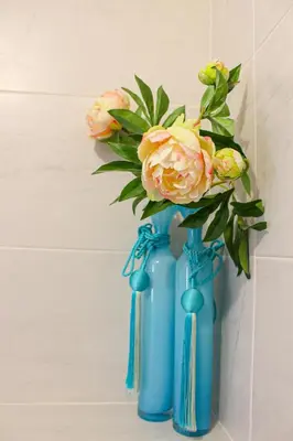 two blue vases with flowers in them on a wall at Spacious Duplex with Terrace City Center in Aix-en-Provence
