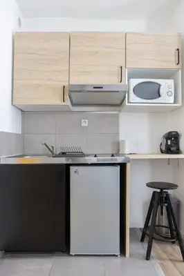 a kitchen with a white refrigerator and a microwave at Le Cézanne - Studio Hypercentre - Wifi - Train station in Aix-en-Provence