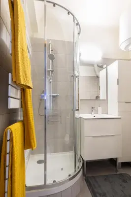 a bathroom with a glass shower and a sink at Le Cézanne - Studio Hypercentre - Wifi - Train station in Aix-en-Provence