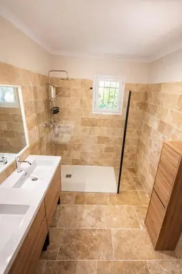 a bathroom with a tub and a sink at Maison en pierre avec piscine chauffée, jacuzzi et vue sur Gordes in Gordes