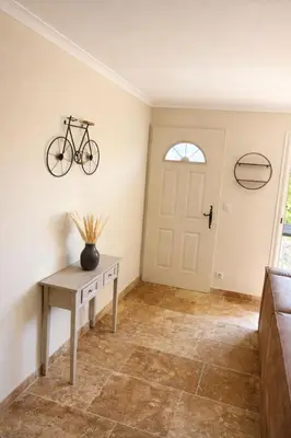 a bike on the wall in a room with a table at Maison en pierre avec piscine chauffée, jacuzzi et vue sur Gordes in Gordes