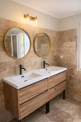 a bathroom with a sink and two mirrors at Maison en pierre avec piscine chauffée, jacuzzi et vue sur Gordes in Gordes