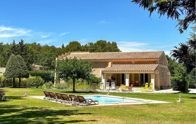 a house with chairs and a pool in front of it at Lovely Home In St Cannat in Saint-Cannat