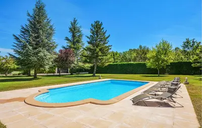 a swimming pool with lounge chairs next to a yard at Lovely Home In St Cannat in Saint-Cannat