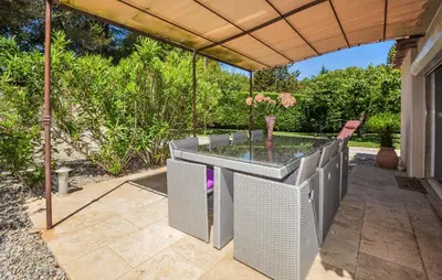 a patio with a glass table and chairs under a pergola at Lovely Home In St Cannat in Saint-Cannat