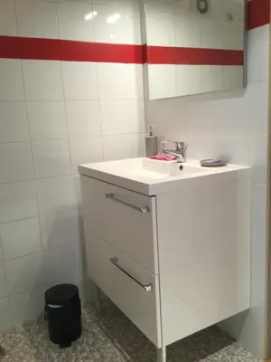 a bathroom with a white sink and a mirror at 1 chambre 1 cuisine & salle d'eau privées avec piscine et jacuzzi in Eyragues