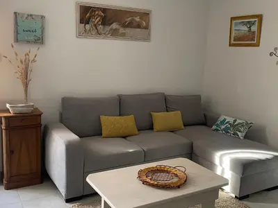 a living room with a couch and a coffee table at Le gîte de Cambuisson in Velleron