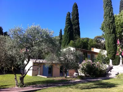 a house in the middle of a garden with trees at Maisonnette dans un parc du 18ème in Aix-en-Provence