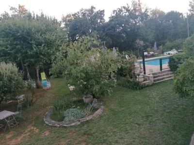 a backyard with a swimming pool and a garden at Les chênes du lac in Saint-Saturnin-les-Apt