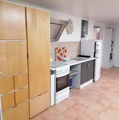a kitchen with a stove top oven and a refrigerator at Les chênes du lac in Saint-Saturnin-les-Apt