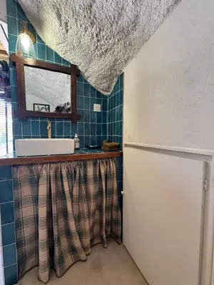 a kitchen with a sink and a refrigerator at CaBaNa 52 La Suite troglodyte Proche Lourmarin in Cadenet