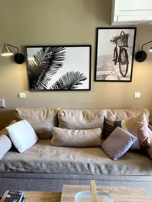 a living room with a couch and a bike on the wall at Élégant appartement sur le Golf de Pont Royal in Mallemort