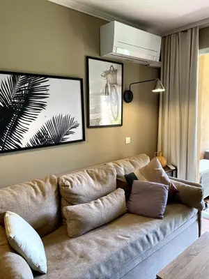 a living room with a brown couch in a room at Élégant appartement sur le Golf de Pont Royal in Mallemort