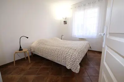 a white bedroom with a bed and a window at Three bedrooms apartment in Aix en Pce in Aix-en-Provence