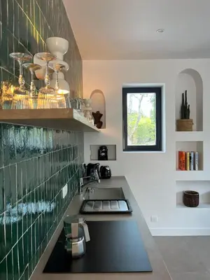 a kitchen with a sink and a counter top at La Réserve Hôtes in Aix-en-Provence