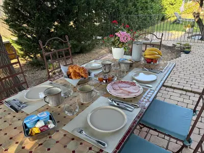 a table with plates of food on top of it at Au Bon Mistral in Monteux