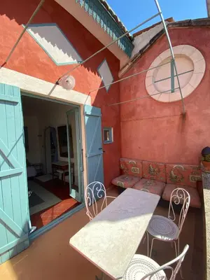 a patio with a table and chairs on a balcony at Syrius - Artist's apartment with terrace and view in Fontaine-de-Vaucluse