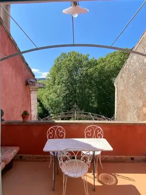a living room with a door open to a patio at Syrius - Artist's apartment with terrace and view in Fontaine-de-Vaucluse