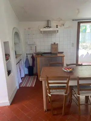 a kitchen with a table and chairs in a room at Syrius - Artist's apartment with terrace and view in Fontaine-de-Vaucluse