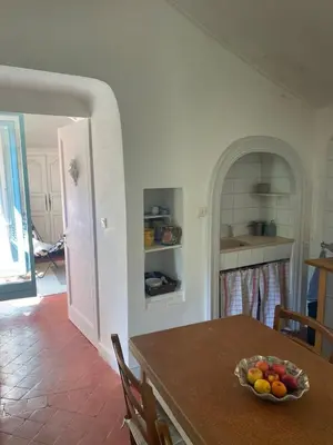 a kitchen with a table with a bowl of fruit on it at Syrius - Artist's apartment with terrace and view in Fontaine-de-Vaucluse