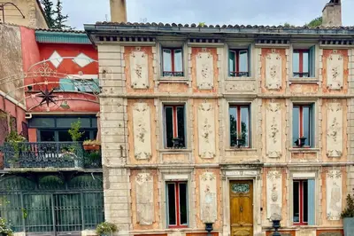 an old stone building with a yellow door at Syrius - Artist's apartment with terrace and view in Fontaine-de-Vaucluse
