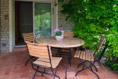 a wooden table and chairs on a patio at Catherine&Martial in Maubec