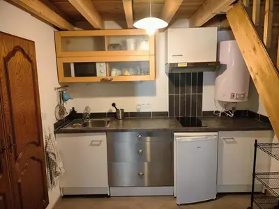 a kitchen with white cabinets and a sink at GitesLuberon 3 in Charleval