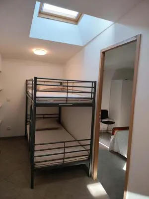 a room with two bunk beds and a mirror at GitesLuberon 4 in Charleval
