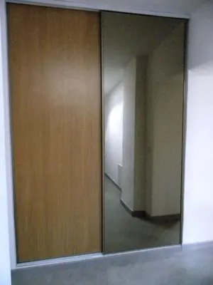 a mirror in a room with a door and a hallway at GitesLuberon 4 in Charleval