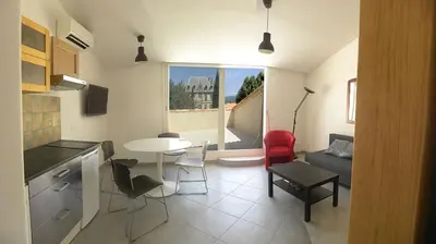 a kitchen and living room with a table and chairs at GitesLuberon 5 in Charleval