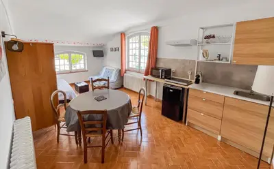a kitchen and dining room with a table and chairs at Mon coeur de Provence in Banon
