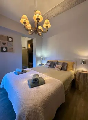 a bedroom with a bed with a hat on it at Le Mas de Cabrières in Cabrières-dʼAvignon