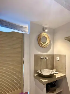 a bathroom with a sink and a mirror on the wall at Le Mas de Cabrières in Cabrières-dʼAvignon