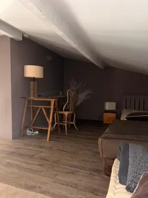 a bedroom with a desk and a bed and a table at Le Mas de Cabrières in Cabrières-dʼAvignon